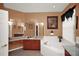 Bright bathroom with granite countertops, soaking tub, and large mirror with good lighting at 451 Montara Dr, Davenport, FL 33897