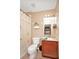 Cozy bathroom includes a toilet, vanity with granite countertop and a shower with a tropical curtain at 451 Montara Dr, Davenport, FL 33897
