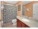 Well-lit bathroom featuring a shower/tub, vanity with granite countertop, and tile flooring at 451 Montara Dr, Davenport, FL 33897
