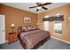 Comfortable bedroom with a king-sized bed, ceiling fan, and windows for natural light at 451 Montara Dr, Davenport, FL 33897