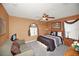 Bedroom showcasing neutral tones, ceiling fan, comfortable furniture and window with attractive valance at 451 Montara Dr, Davenport, FL 33897