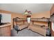 Bedroom with multiple bunk beds, carpeted flooring, ceiling fan, and window with attractive valance at 451 Montara Dr, Davenport, FL 33897