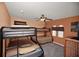 Bedroom with multiple bunk beds, a ceiling fan, carpeted flooring and window with attractive valance at 451 Montara Dr, Davenport, FL 33897