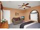 Neutral bedroom featuring ceiling fan, comfortable furniture, and a mounted television at 451 Montara Dr, Davenport, FL 33897