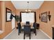 Formal dining room featuring a glass table, upholstered chairs, decorative lighting, and a neutral color palette at 451 Montara Dr, Davenport, FL 33897