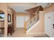 Entryway with tiled floors and a staircase leading upstairs, featuring decorative wall art and neutral colors at 451 Montara Dr, Davenport, FL 33897