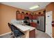 Well-equipped kitchen boasting granite countertops, stainless steel appliances, and seating at the breakfast bar at 451 Montara Dr, Davenport, FL 33897