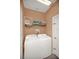 Functional laundry room with a washer, dryer, storage shelf, and convenient layout at 451 Montara Dr, Davenport, FL 33897