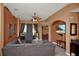 Inviting living room featuring a comfortable gray sofa, ceiling fan, and sliding glass doors to the outside at 451 Montara Dr, Davenport, FL 33897