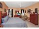 Comfortable primary bedroom with ceiling fan, tile floors, dresser and mirror at 451 Montara Dr, Davenport, FL 33897
