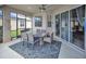 Outdoor living space featuring a screened patio with dining table and chairs with access to backyard at 451 Montara Dr, Davenport, FL 33897