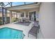 Lanai featuring a seating and dining area near the pool with a lounge chair for relaxation at 451 Montara Dr, Davenport, FL 33897