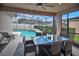 Outdoor living space featuring a screened patio with dining table and chairs with views of pool and backyard at 451 Montara Dr, Davenport, FL 33897