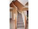 Elegant staircase with carpeted steps, wooden banisters, and white spindles, leading to the upper level at 451 Montara Dr, Davenport, FL 33897