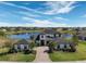 Expansive home with a lake view, lush landscaping, and a brick driveway in a serene neighborhood setting at 4717 Emerald Palms Ct, Winter Haven, FL 33884