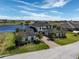 Stunning aerial view of an estate home with lakefront access, a brick driveway, and lush landscaping at 4717 Emerald Palms Ct, Winter Haven, FL 33884