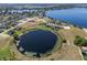 An aerial view showing a neighborhood of lakefront homes on a picturesque lake at 4717 Emerald Palms Ct, Winter Haven, FL 33884