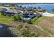 Aerial shot of a home with an outdoor pool located on a lake at 4717 Emerald Palms Ct, Winter Haven, FL 33884