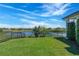 Expansive backyard overlooking lake with aluminum fence at 4717 Emerald Palms Ct, Winter Haven, FL 33884