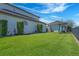 Expansive backyard with playset, well-manicured landscaping, and aluminum fence at 4717 Emerald Palms Ct, Winter Haven, FL 33884