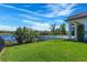Expansive backyard with in-ground pool, aluminum fence, and lake view at 4717 Emerald Palms Ct, Winter Haven, FL 33884