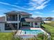 Backyard with a pool, screened lanai, and lake views, offering a private outdoor oasis at 4717 Emerald Palms Ct, Winter Haven, FL 33884
