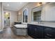 Bathroom featuring a soaking tub, dual sinks, and wood-look tile floors at 4717 Emerald Palms Ct, Winter Haven, FL 33884