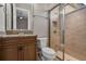 Bathroom vanity with granite countertop, wood cabinet and updated tiled shower at 4717 Emerald Palms Ct, Winter Haven, FL 33884