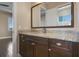 Bathroom vanity with granite countertop, wood cabinets, and large mirror at 4717 Emerald Palms Ct, Winter Haven, FL 33884
