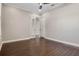 Bedroom featuring dark hardwood floors, a ceiling fan, and double doors at 4717 Emerald Palms Ct, Winter Haven, FL 33884