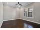 Bedroom featuring dark hardwood floors, a ceiling fan, and a large window at 4717 Emerald Palms Ct, Winter Haven, FL 33884
