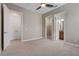 Spacious bedroom with neutral carpet and access to bathroom and walk-in closet at 4717 Emerald Palms Ct, Winter Haven, FL 33884
