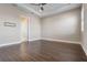 Neutral-toned bedroom with tray ceiling and door leading to hallway at 4717 Emerald Palms Ct, Winter Haven, FL 33884