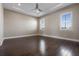 Light-filled bedroom with two windows and dark wood floors at 4717 Emerald Palms Ct, Winter Haven, FL 33884