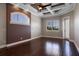 Bedroom with dark hardwood floors, coffered ceiling, fan, and windows at 4717 Emerald Palms Ct, Winter Haven, FL 33884