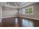 Spacious bedroom with dark wood floors, recessed lighting, large windows, and neutral walls at 4717 Emerald Palms Ct, Winter Haven, FL 33884