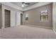 Spacious bedroom with neutral carpet, closet, and tray ceiling with fan at 4717 Emerald Palms Ct, Winter Haven, FL 33884