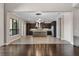 Bright and spacious kitchen with a large island, modern appliances, wood-look tile flooring and stylish pendant lighting at 4717 Emerald Palms Ct, Winter Haven, FL 33884