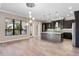 Open kitchen featuring stainless steel appliances, a large island with seating, and natural light from a large window at 4717 Emerald Palms Ct, Winter Haven, FL 33884