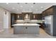 Bright kitchen with a large island, stainless steel appliances, granite countertops and dark wood cabinets at 4717 Emerald Palms Ct, Winter Haven, FL 33884
