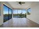 Spacious lanai features tile flooring, large windows and screened enclosure overlooking a beautiful lake at 4717 Emerald Palms Ct, Winter Haven, FL 33884