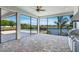 The covered lanai features an outdoor kitchen, overlooks the pool and a beautiful lake view at 4717 Emerald Palms Ct, Winter Haven, FL 33884