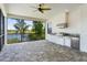 Covered lanai with a full outdoor kitchen featuring a built-in grill, sink, and refrigerator at 4717 Emerald Palms Ct, Winter Haven, FL 33884