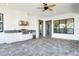 Outdoor lanai with a full outdoor kitchen featuring a built-in grill, sink, and refrigerator at 4717 Emerald Palms Ct, Winter Haven, FL 33884