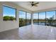 Bright, screened lanai featuring tile flooring and tranquil views of the surrounding lake and greenery at 4717 Emerald Palms Ct, Winter Haven, FL 33884