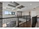 Open landing with hardwood floors and view of two-story stone fireplace at 4717 Emerald Palms Ct, Winter Haven, FL 33884