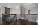Open landing with chandelier and hardwood floors at 4717 Emerald Palms Ct, Winter Haven, FL 33884
