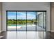 Bright living space with dark wood floors and sliding glass doors overlooking the pool and backyard at 4717 Emerald Palms Ct, Winter Haven, FL 33884