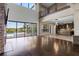 Spacious living room with a stone fireplace, modern lighting, and large glass doors overlooking a pool at 4717 Emerald Palms Ct, Winter Haven, FL 33884