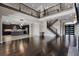 Open-concept living area with dark wood floors, a modern kitchen, and a grand staircase at 4717 Emerald Palms Ct, Winter Haven, FL 33884